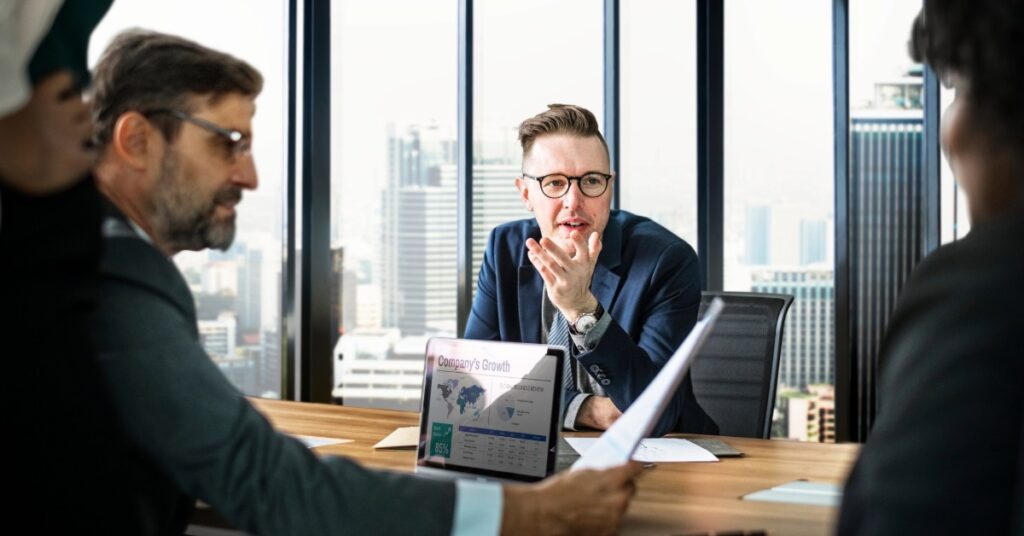 CFO reviewing business reports during a leadership meeting while evaluating IT security and risk