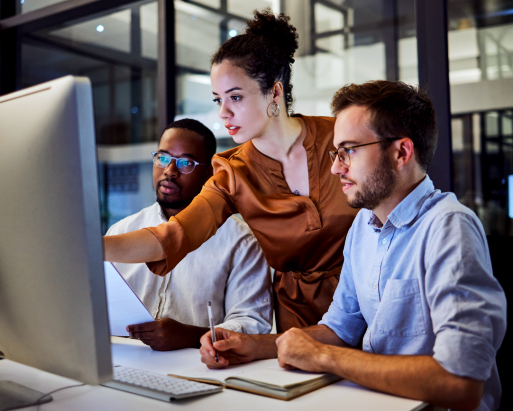 Business team reviewing a decision tree on a computer during a collaborative planning discussion.